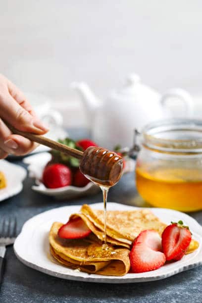 Plat de crêpes avec miel et fruits